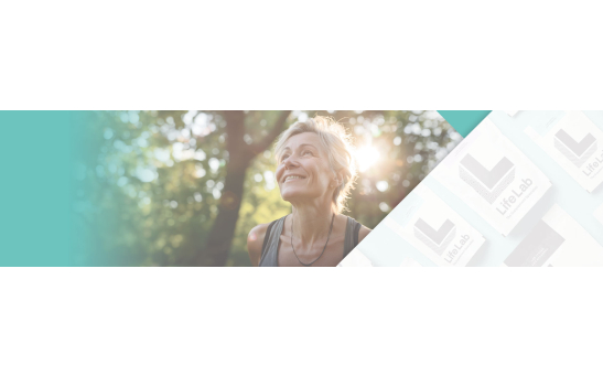 Woman taking a walk through the park, looking up into the sky, happy